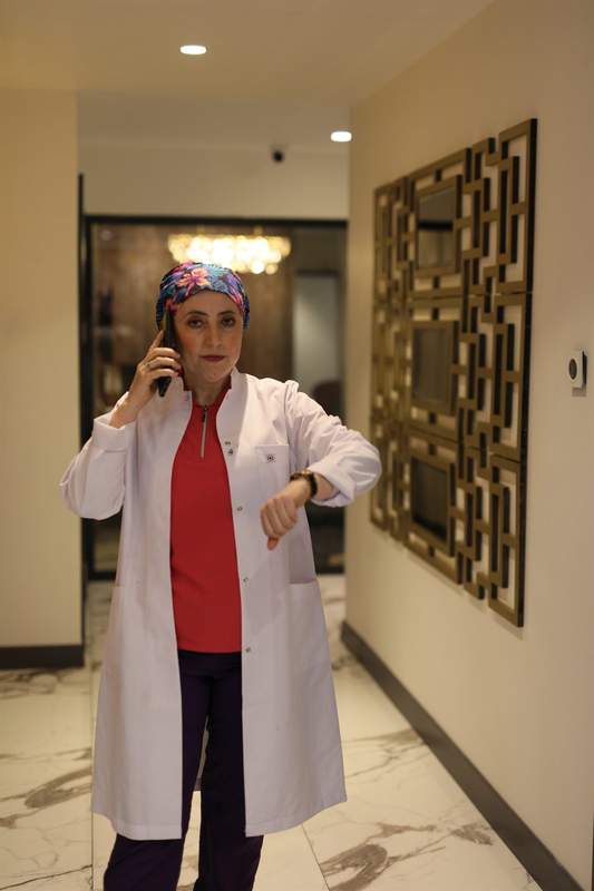 Dr. İhsaniye Dönmez Çiçek speaking by phone at the clinic